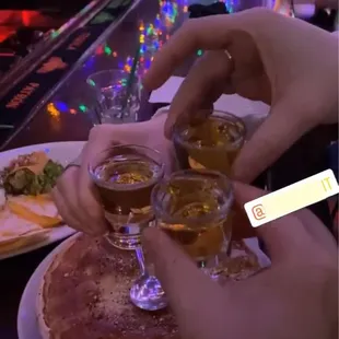 a group of people clinking glasses of beer