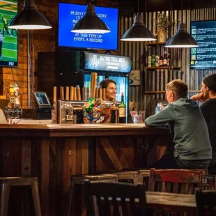 two men sitting at a bar