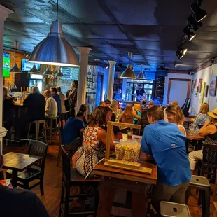 people sitting at tables in a restaurant
