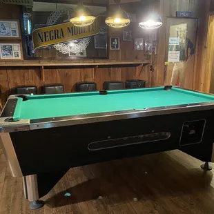 a pool table in the middle of the room