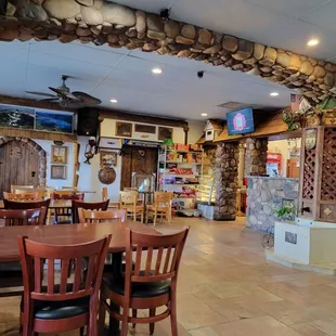 a restaurant with a stone wall