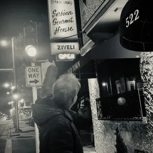 a woman reaching for a sign