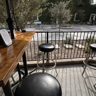 a wooden table with black stools