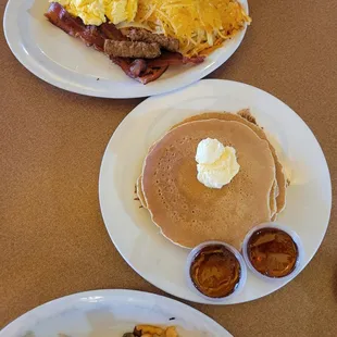 a breakfast of pancakes, bacon, eggs, and bacon