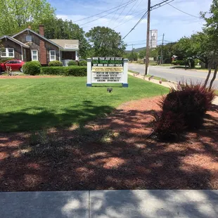 a sign in front of a house