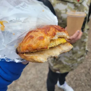 a person holding a sandwich