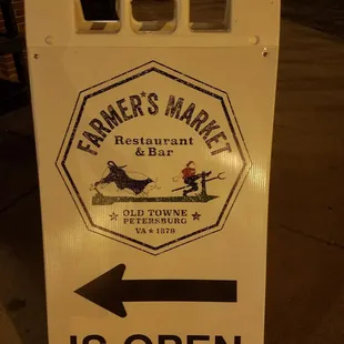 an arrow pointing to an open sign