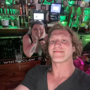 a man and a woman sitting at a bar