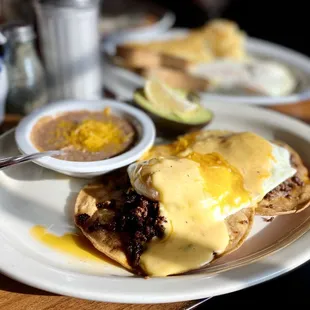 Papi's Huevos! Ole! Crispy corn tortillas 2 eggs over easy chorizo, beans queso salsa avocado &amp; side of fresh jalapeño! :)...