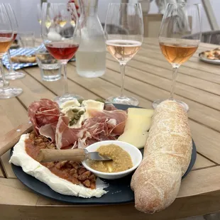 Charcuterie board with local cheeses and meats and homemade bread