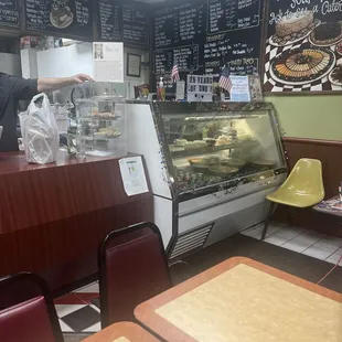 a man standing in front of a deli counter