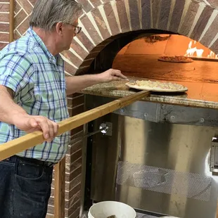 They don't just put the pizzas in and wait for a timer to tell them they're done.  They sit and watch and pop all the dough bubbles.
