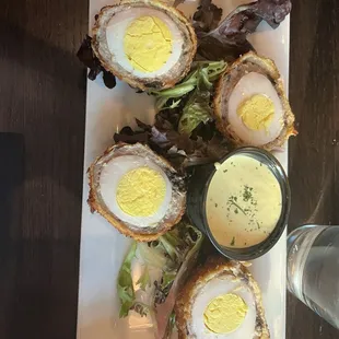 Scottish Egg with a mustard sauce. These were very good.  In Scotland you tend to get more sausage the. Egg.