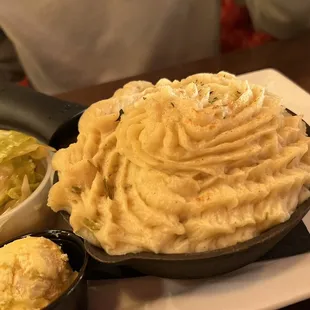 a plate of mashed potatoes and pickles