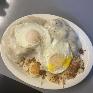 Biscuits and gravy with over easy eggs and hash browns