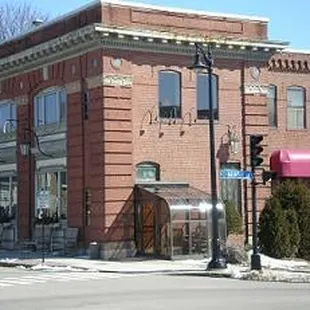 a brick building with a pink awning