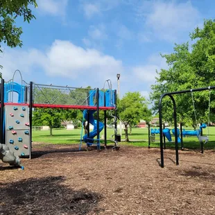 Baby swings, musical instruments, rock wall, slides