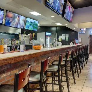 a bar with a row of bar stools