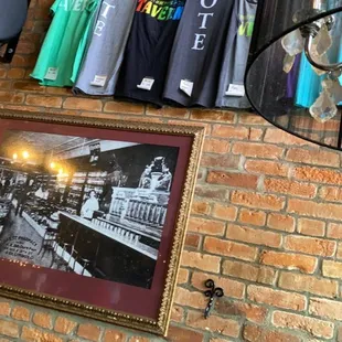 t - shirts hanging on a brick wall