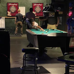 a young boy playing pool