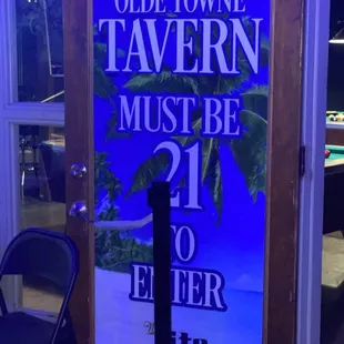 a sign in front of a pool table