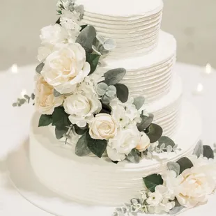 a wedding cake with white flowers