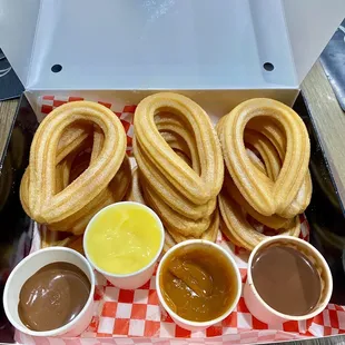 Olé Combo! 15 churros with Nutella, Bavarian Cream, Dulce de Leche and Spanish Hot Chocolate.