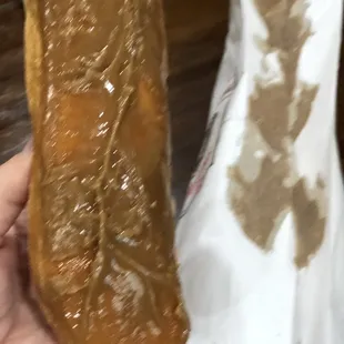 Maple bar with half the maple still stuck to the bag.