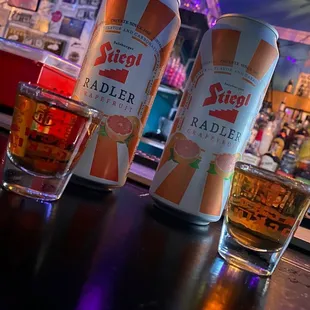 two cans of beer on a bar