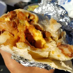 Interior of vegan breakfast burrito ($12). Not good. Starchy, bland mess of beans, Just Egg &amp; too much Violife mozzarella.