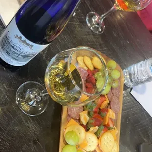  bottle of wine and a platter of food