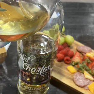  glass of white wine being poured