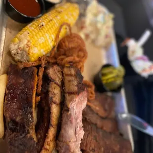 OLE RED SMOKED MEAT PLATTER Smoked Brisket, Chorizo Hot Link, St. Louis-Style Ribs, Grilled Corn, Tishomingo Potato Salad, Vinegar Slaw