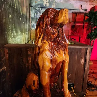 a wooden statue of a lion