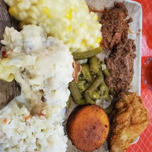 Clockwise - chipped pork, chipped mutton, fried chicken, cornbread muffin, green beans, slaw, potato salad cream corn