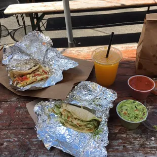 a sandwich and a drink on a picnic table