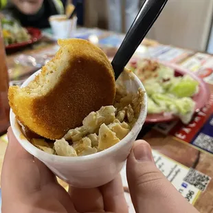 a person holding a bowl of food