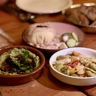 Pistachio Muhammara, gigant bean salad in the front Topik and Za&apos;tar bread in the back