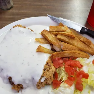 a plate of food with fries and gravy