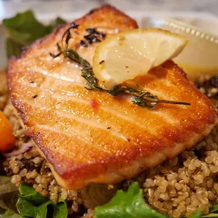 Roasted salmon on quinoa w/ roasted brussels sprouts on greens w/ turmeric dressing