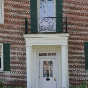 Village entry with original copper roof and wrought iron details from 1939.