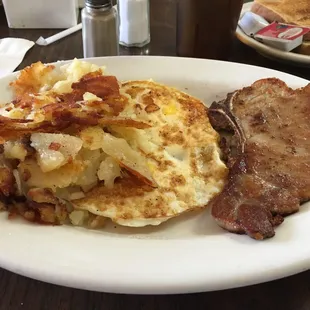 Pork chop, eggs and home fries