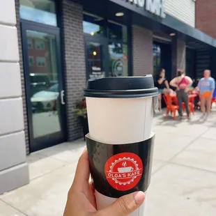 a hand holding a cup of coffee