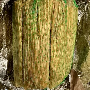 Tamales - green netting means spicy pork