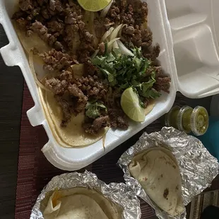 Asada tacos (6.99) and the daily taco special (2.10).