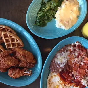 Chicken and waffles with a side of sautéed spinach and mashed potatoes. Chilaquiles, beans, and over hard eggs