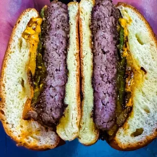 two hands holding a hamburger