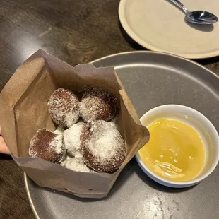 a plate of donuts and a bowl of sauce