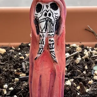 a clay figure of a skeleton in a hood