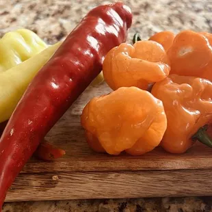 a cutting board with peppers and peppers on it